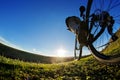 Detail of cyclist man feet riding mountain bike on outdoor trail in sunny meadow Royalty Free Stock Photo