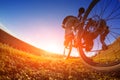 Detail of cyclist man feet riding mountain bike on outdoor trail in sunny meadow Royalty Free Stock Photo