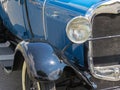 Detail of the classic old blue car front. Royalty Free Stock Photo