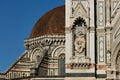 detail of decorations on the facade of Florence Cathedral, Basilica di Santa Maria del Fiore with behind Brunelleschi\'s dome Royalty Free Stock Photo