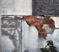 Detail of a demolition house with chipped plaster and recognizable red bricks underneath Royalty Free Stock Photo