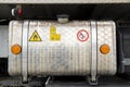 Detail of the diesel tank of a parked truck. Hazard labels are attached