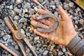 Detail of dirty hand holding horseshoe Royalty Free Stock Photo