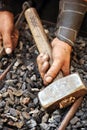 Detail of dirty hands holding hammer Royalty Free Stock Photo