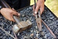 Detail of dirty hands holding hammer and pliers Royalty Free Stock Photo