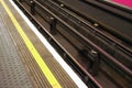 Detail on dirty rails near platform in London underground tube station Royalty Free Stock Photo