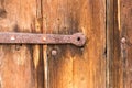 Detail of the door hinge on old vintage wooden door Royalty Free Stock Photo