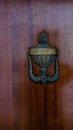 detail of door knocker on brown door. Menorca, Balearic Islands, Spain