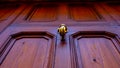 detail of door knocker on brown door. Menorca, Balearic Islands, Spain