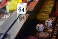 Detail of the doubling cube on the center rail of a lacquered backgammon board, macro Royalty Free Stock Photo