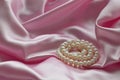 Detail of draped pink silk fabric with pearl