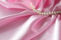 Detail of draped white and pink silk fabric with pearl