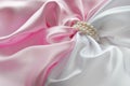 Detail of draped white and pink silk with pearl jewelry