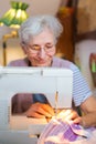 elderly woman sewing Royalty Free Stock Photo