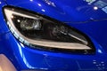 Detail of elegant left headlight of modern 2+2 japanese fastback coupe sports car Subaru BRZ