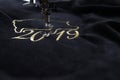Detail of embroidery machine stitching 2019 chinese new year motive with precious gold yarn on black velvet Royalty Free Stock Photo