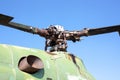 Detail of engine cover housing and rotors of an old military helicopter against blue sky