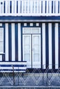 Detail of the entrance door of a typical charming Costa Nova house, with blue and white stripes.