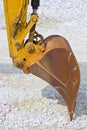 Detail of excavator`s bucket at a gravel seaside Royalty Free Stock Photo