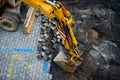 Detail of the excavator working on the cobblestone street reconstruction