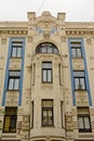 Detail of facade of Art deco buildlding with faces and abstract decorations Royalty Free Stock Photo