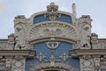 Detail of facade of Art deco building with big male faces and abstract decorations Royalty Free Stock Photo