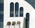 Detail of facade modern building - front view at arched windows of different shapes and sizes.