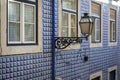 Detail of the facade of an old building with Portuguese Tiles Azulejo and a lamp post in the Alfama Neighborhood in Lisbon Royalty Free Stock Photo