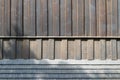 Detail of the facade of an old wooden church. Wooden boards and wooden shingles. The shadow from the trees is cast on the facades Royalty Free Stock Photo