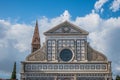 Detail of facade of Santa Maria Novella church and Romanesque bell tower behind, Florence ITALY