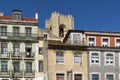 Detail of the facade of traditional buildings with the bell tower of the Lisbon Cathedral on the background in Lisbon, Portugal