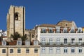 Detail of the facade of traditional buildings with the bell tower of the Lisbon Cathedral on the background in Lisbon, Portugal Royalty Free Stock Photo