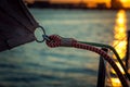 Detail of fastening the sail on a yacht in the rays of the sunset. Shooting on board a yacht on the river Royalty Free Stock Photo