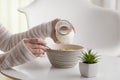 Woman pouring milk into cereal bowl Royalty Free Stock Photo