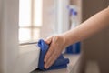 Woman doing home chores wiping windows