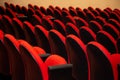 A few rows of red armchairs in an empty theater. Royalty Free Stock Photo