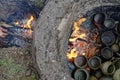Detail of firing an ancient pit fire kiln replica filled with handmade pottery pieces Royalty Free Stock Photo