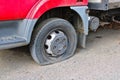 Detail of flat tyre of a truck parked on a crushed stone road Royalty Free Stock Photo
