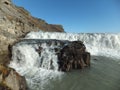 Detail of foamy, white cascading water of Gullfoss in Iceland against blue sky Royalty Free Stock Photo