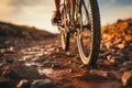 Detail focus Close up of mountain bike tire and riders foot on dirt road Royalty Free Stock Photo