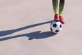 Detail of a foot on the ball on a concrete floor Royalty Free Stock Photo