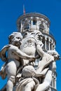 Detail of the Fountain Putti Fountain and the Leaning Tower of Pisa at the Piazza dei Miracoli in Pisa, Tuscany, Italy Royalty Free Stock Photo