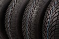 Detail of four winter tires stack background Royalty Free Stock Photo