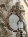 Detail of a baroque frame with a painting of Jesus in Via dei Coronari to Rome in Italy.