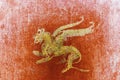 detail of the fresco in Pompeii with winged griffin on a red background Pompeian. Royalty Free Stock Photo