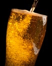 Detail of fresh beer pouring from bottle into glass Royalty Free Stock Photo