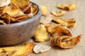 Detail of fried carrot and parsnip chips in rustic wood bowl. Royalty Free Stock Photo