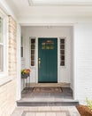 A front door detail with white brick and stone and a blue - green front door. Royalty Free Stock Photo