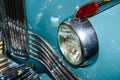 Detail of the front headlight of an old car in garage Royalty Free Stock Photo