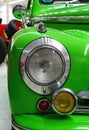 Detail of front mask and headlight of classical veteran small czechoslovak family car Skoda 1102 from year 1950